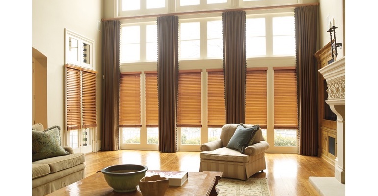 Cincinnati great room with natural wood blinds and full-length draperies.
